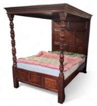 A 19th century style tester bed, oversailing canopy with crossbanded fielded panneled details,