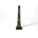 A large pietra dura obelisk, inlaid with an irregular field of malachite, lapis lazuli and other