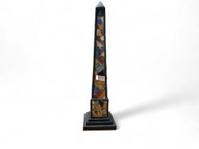 A large pietra dura obelisk, inlaid with an irregular field of malachite, lapis lazuli and other