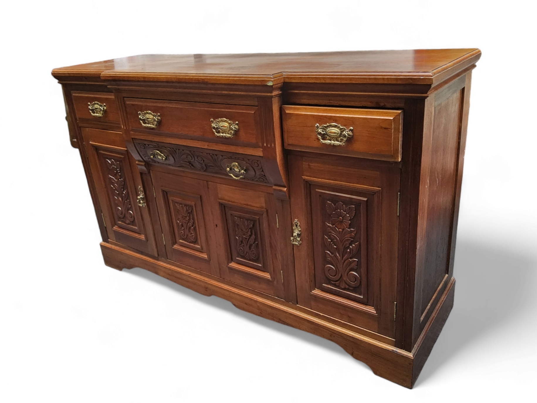 An Edwardian mahogany breakfront sideboard, stepped top over three drawers and four doors, bracket