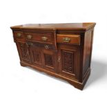 An Edwardian mahogany breakfront sideboard, stepped top over three drawers and four doors, bracket