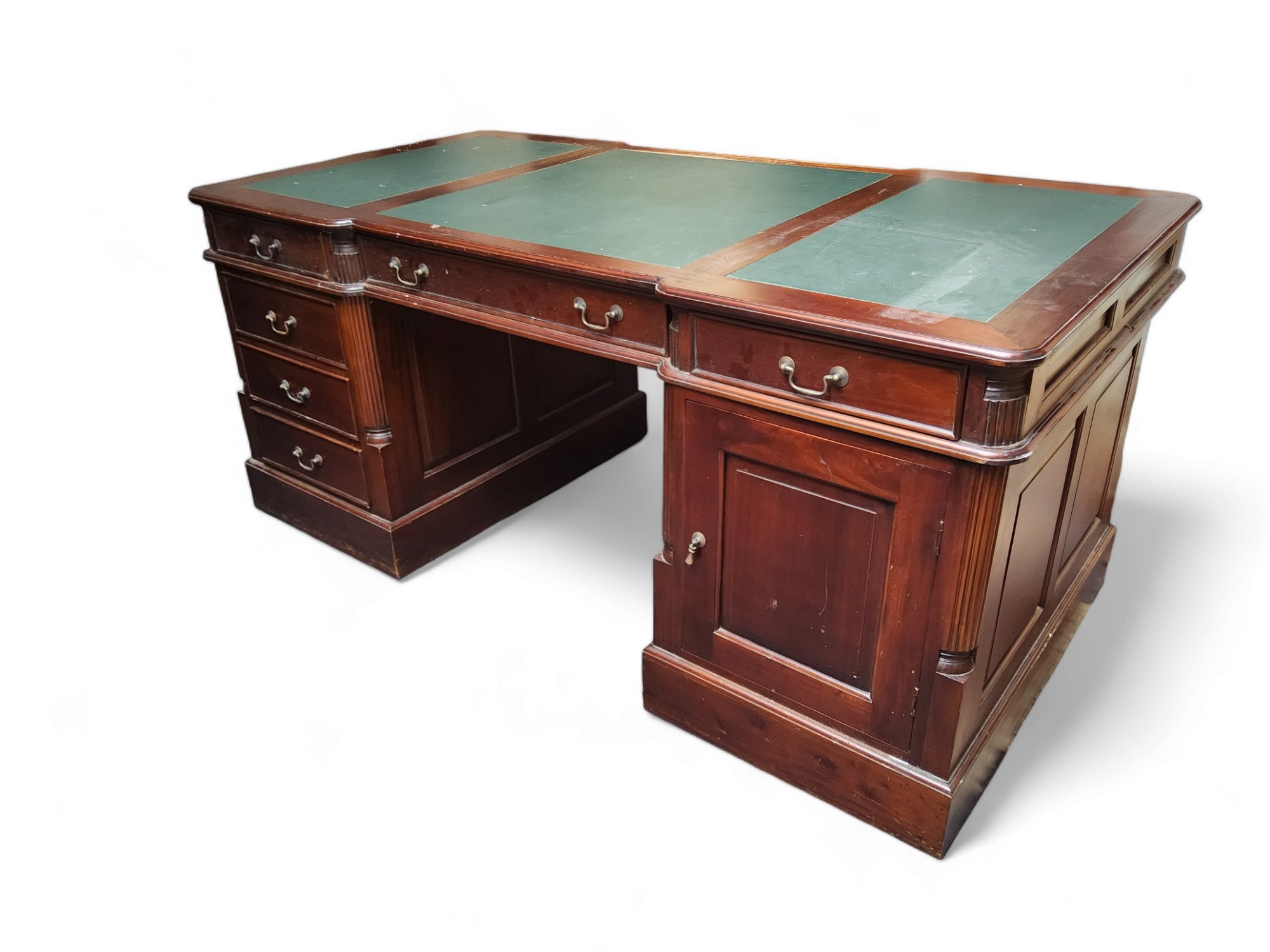 An early 20th century mahogany twin pedestal partners desk, three panel leather writing surface with