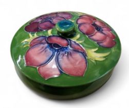 A Moorcroft  Anemone  bowl and cover, tube lined with large flower heads, on a green ground, 12cm