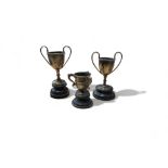 A silver miniature trophy cup, 5.5cm high, Birmingham 1906;  another, Birmingham 1907;  a three tyg,