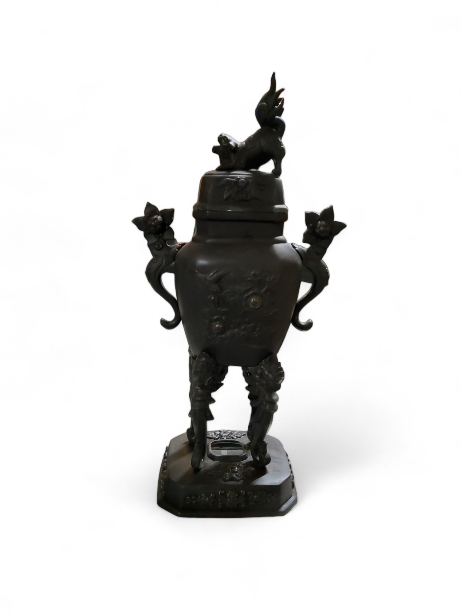 A Japanese bronzed koro, Dog of Fo finial, scroll handles, high scroll legs, canted rectangular