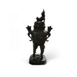 A Japanese bronzed koro, Dog of Fo finial, scroll handles, high scroll legs, canted rectangular