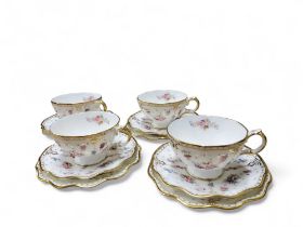 A set of four Royal Crown Derby Royal Antoinette pedestal teacups, saucers and side plates,  printed