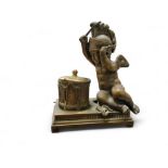 A 19th century bronze novelty inkwell, cast as a putti beating a drum, 15cm high, c.1860