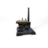 A Marklin brass and tin plate steam engine, with a single fly wheel, pressure gauge and chimney,