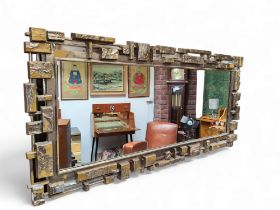 A mid 20th century brutalist wall mirror by Syroco, injection moulded construction.