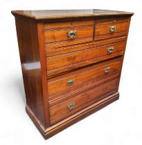 A late Victorian walnut chest, of two short and three long drawers, swing handles, plinth base,