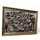 A rectangular mirror, decorated with stylised flowers and foliage, 99cm x 44cm;   another, gilt