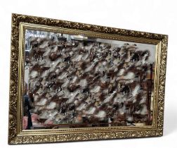 A rectangular mirror, decorated with stylised flowers and foliage, 99cm x 44cm;   another, gilt