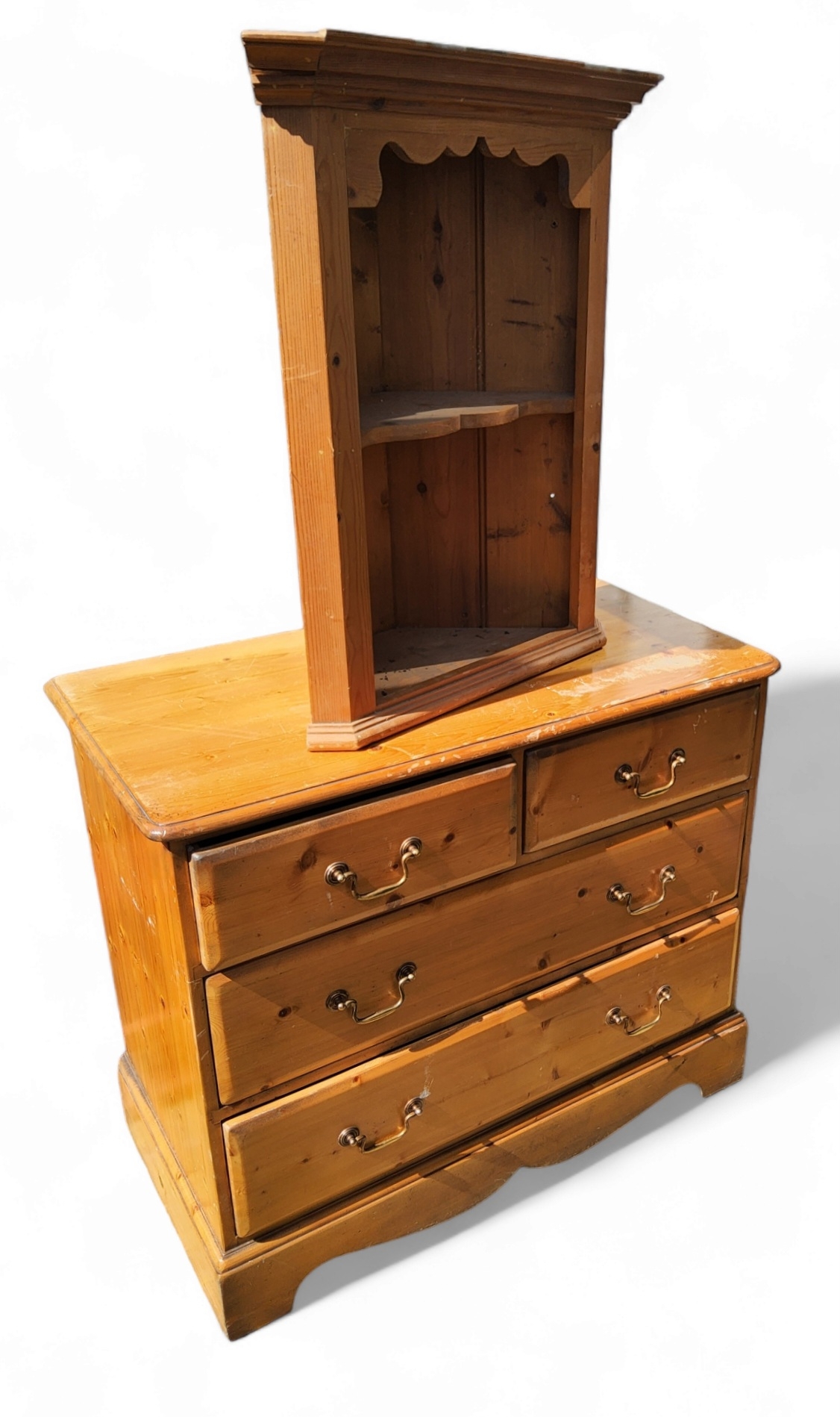 A pine chest of two short and two long drawers, swing handles, bracket feet, 91cm x 48cm; a small