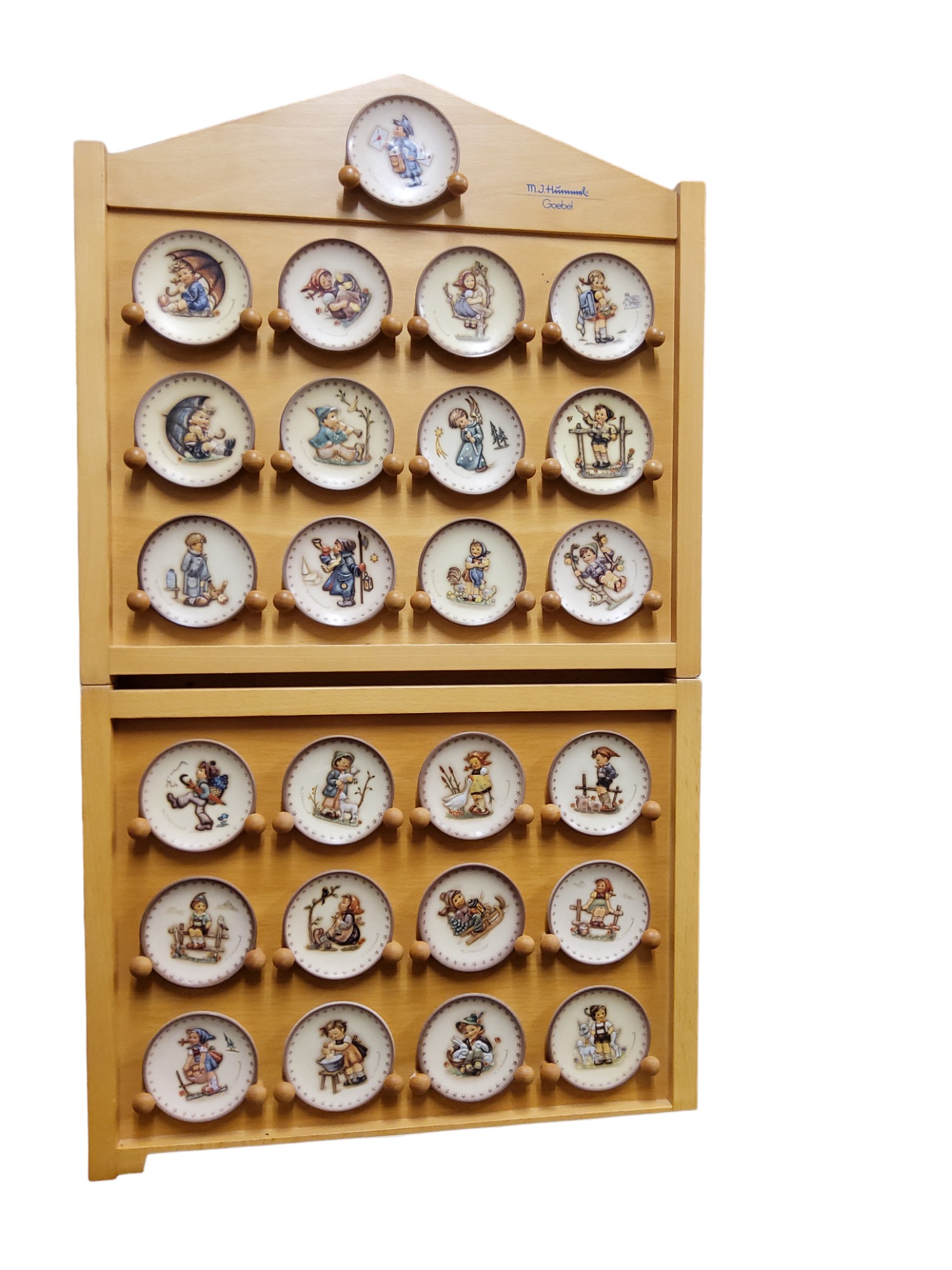 A set of twenty five Goebel miniature plates, designed by M I Hummel, 8cm high, printed marks,