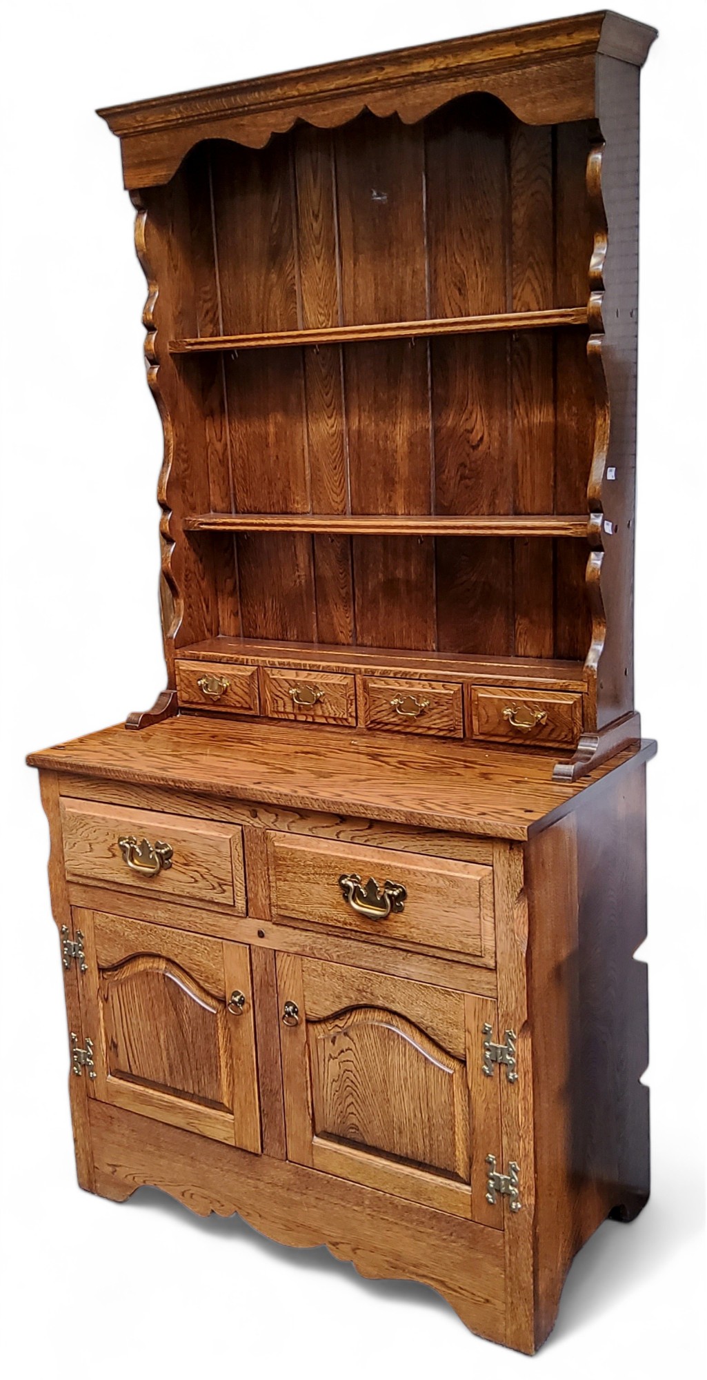 A 20th century oak side cabinet, shaped apron above two shelves and four spice drawers, the