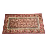 A Royal Keshan woollen rug, pazyryk red ground with geometric pattern, 160cm x 83cm