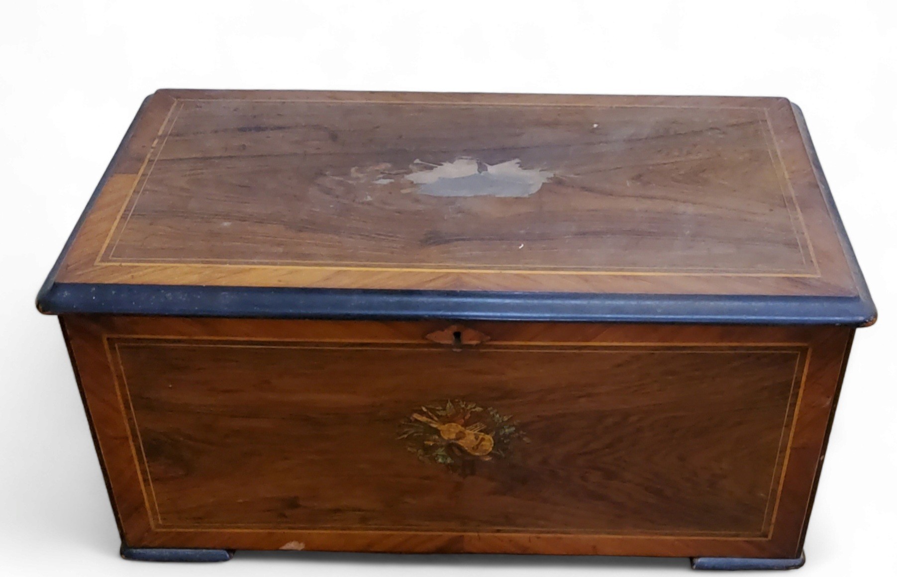 A 19th century Swiss rosewood rectangular music box case, printed with musical trophies, 26cm
