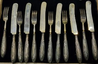 A  set of six silver hafted dessert knives, Sheffield 1964;  a set of six butter knives, anthemion