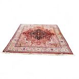 A large Persian Tabriz carpet, machine produced woolen pile, central flowerhead boss bordered with