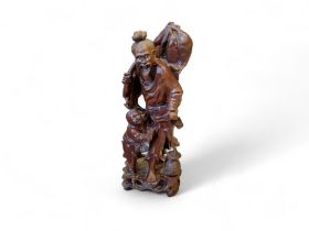 A Japanese padouk figure of a fisherman and child, 36cm high, Meiji period