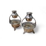 A pair of unusual combination salt and pepper stands, the cauldron salts vertically pierced, loop