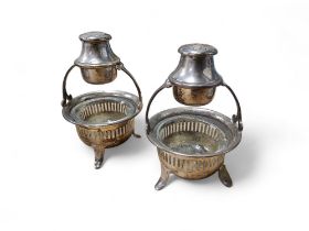 A pair of unusual combination salt and pepper stands, the cauldron salts vertically pierced, loop