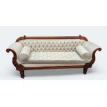 A Victorian mahogany scroll end sofa, upholstered in cream, turned legs. caster feet