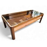 A mid 20th century teak coffee table by Myer, inset smoked glass top, lower tier.