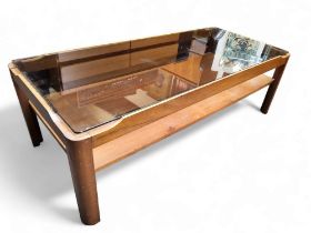 A mid 20th century teak coffee table by Myer, inset smoked glass top, lower tier.
