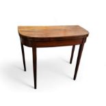 A 19th century mahogany demi-lune card table, folding top enclosing green baize-lined playing