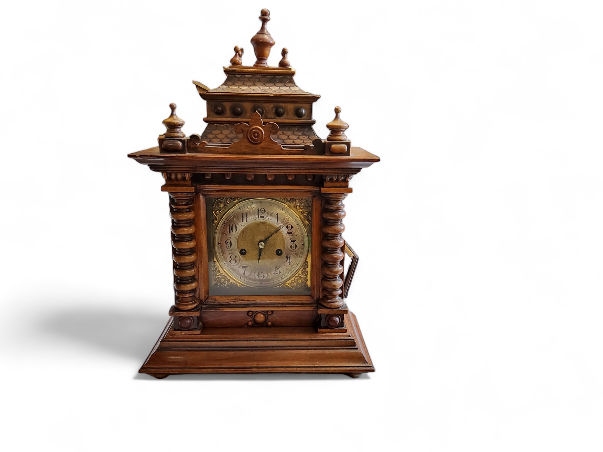 A late 19th century German mantel clock, Arabic numerals, twin winding holes, striking on a gong,