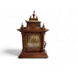 A late 19th century German mantel clock, Arabic numerals, twin winding holes, striking on a gong,
