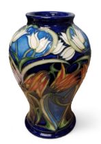 A Moorcroft Loch Hope pattern baluster vases, designed by Philip Gibson, tube lined with snowdrops