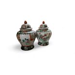 A pair of Chinese famille noire baluster vases and covers, 30cm high, 20th century