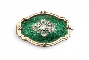 A yellow metal, diamond & enamel brooch, the central green enamelled panel, surmonted white