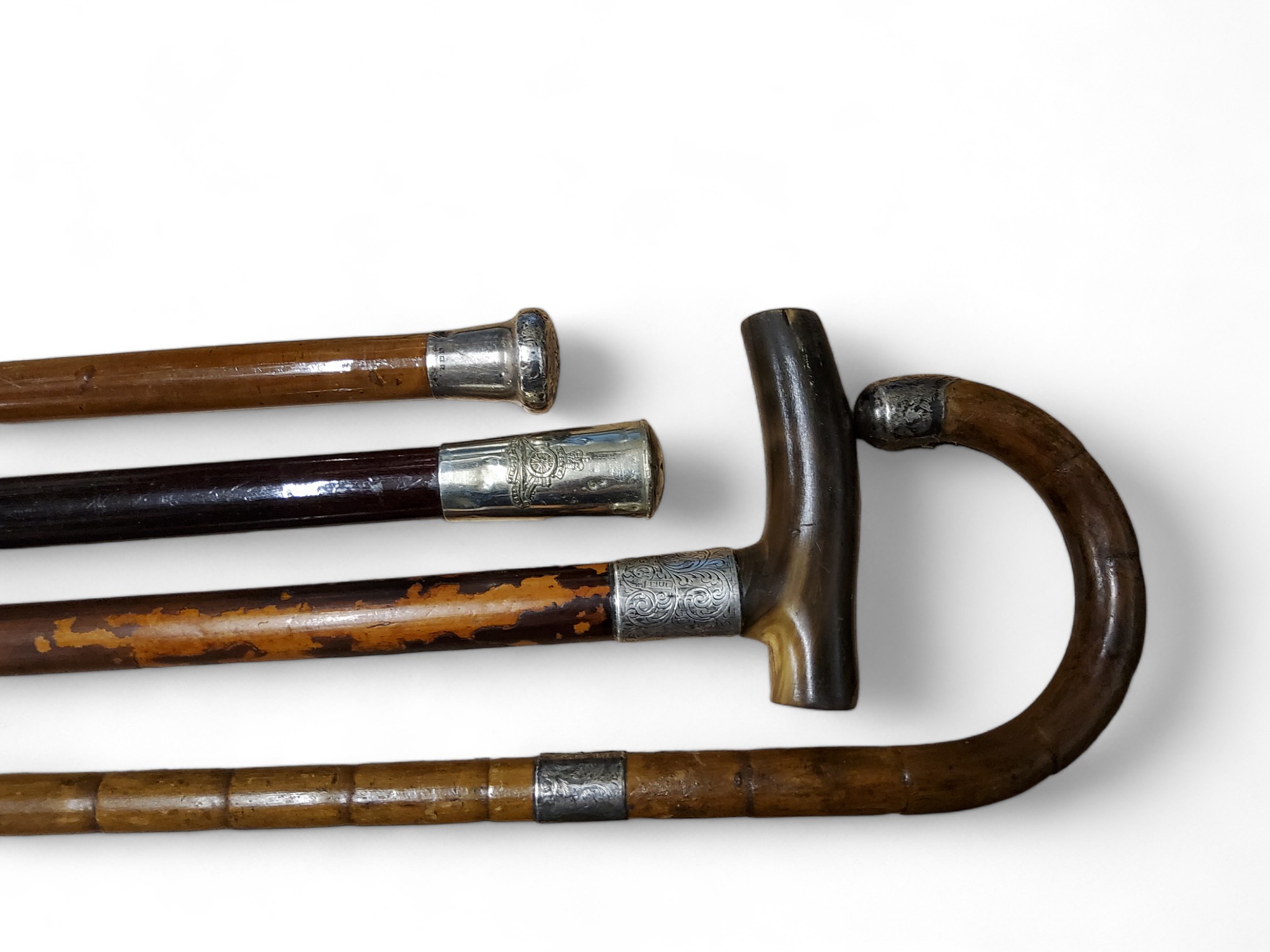 An early 20th century malacca walking cane, silver pommel, 89cm long, London 1918;  others, bamboo