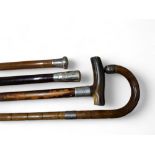 An early 20th century malacca walking cane, silver pommel, 89cm long, London 1918;  others, bamboo