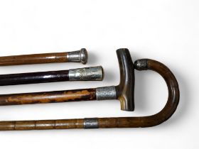 An early 20th century malacca walking cane, silver pommel, 89cm long, London 1918;  others, bamboo