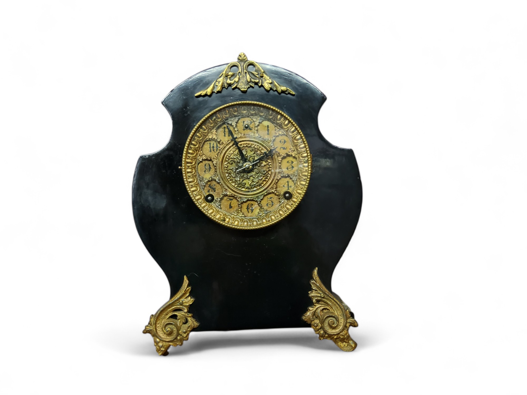 A French cartouche shaped ebonised and gilt mantel clock, 12cm diam with Arabic numerals, two