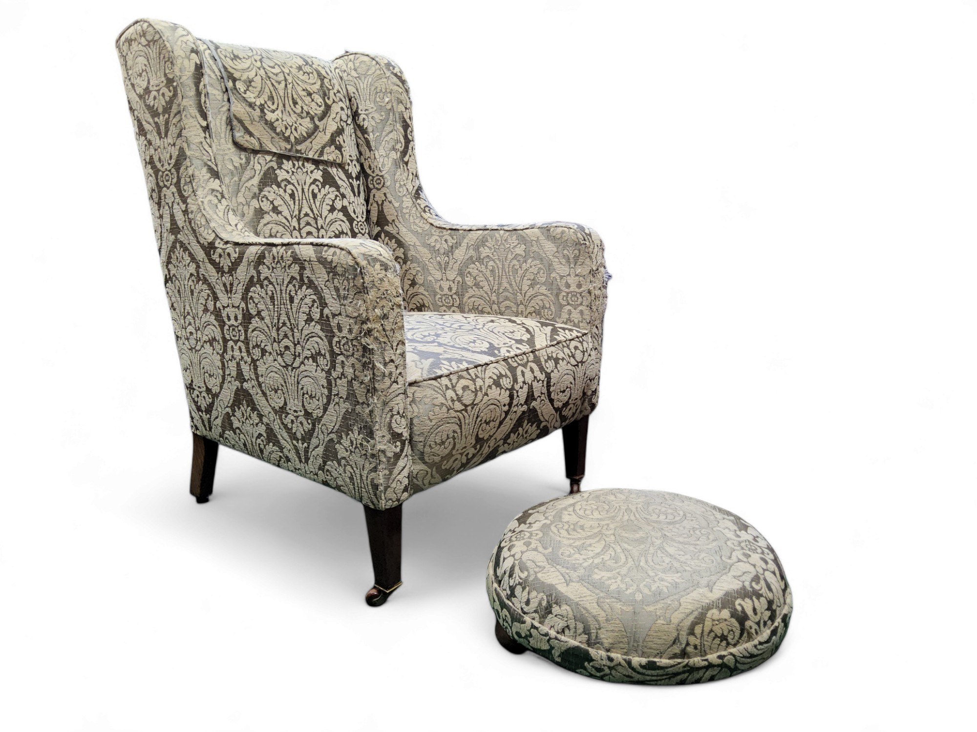 A George III style wingback armchair; conforming footstool (2)