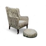 A George III style wingback armchair; conforming footstool (2)