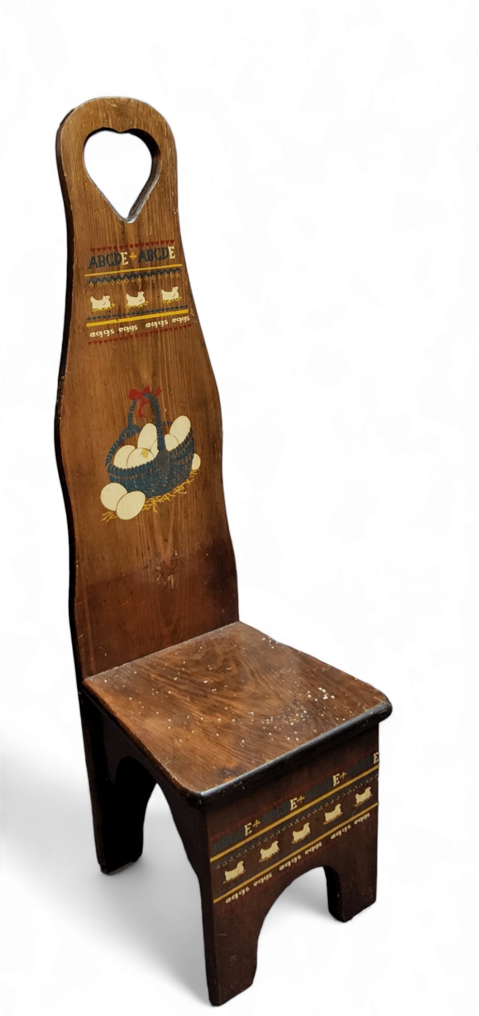 An early 20th century farmhouse spinning stool, hand painted with hens and eggs, 85cm high, 25cm