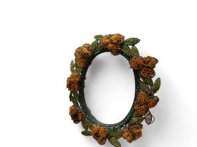 An early 20th century easel  wirework beadwork mirror, in yellow and green, 35cm high, c.1920