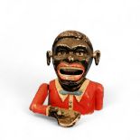 An early 20th century aluminium Jolly Black Man money bank, 15cm high