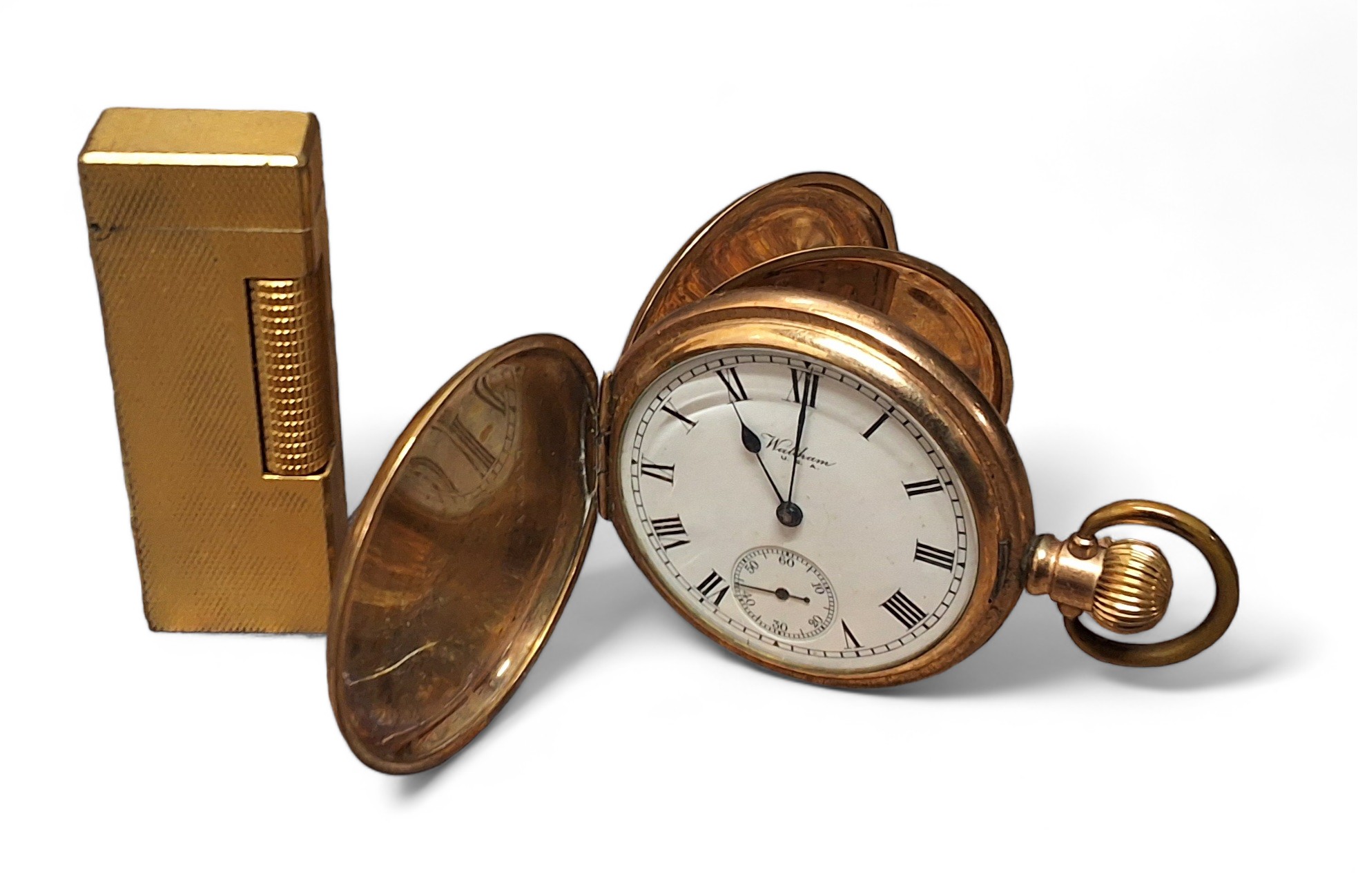 A Dunhill goldplated lighter; a gold plated full hunter pocketwatch, side winder movement stamped