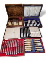 A set of six mother-of-pearl hafted fruit knivesand forks, cased;   a set of six Harrods fruit