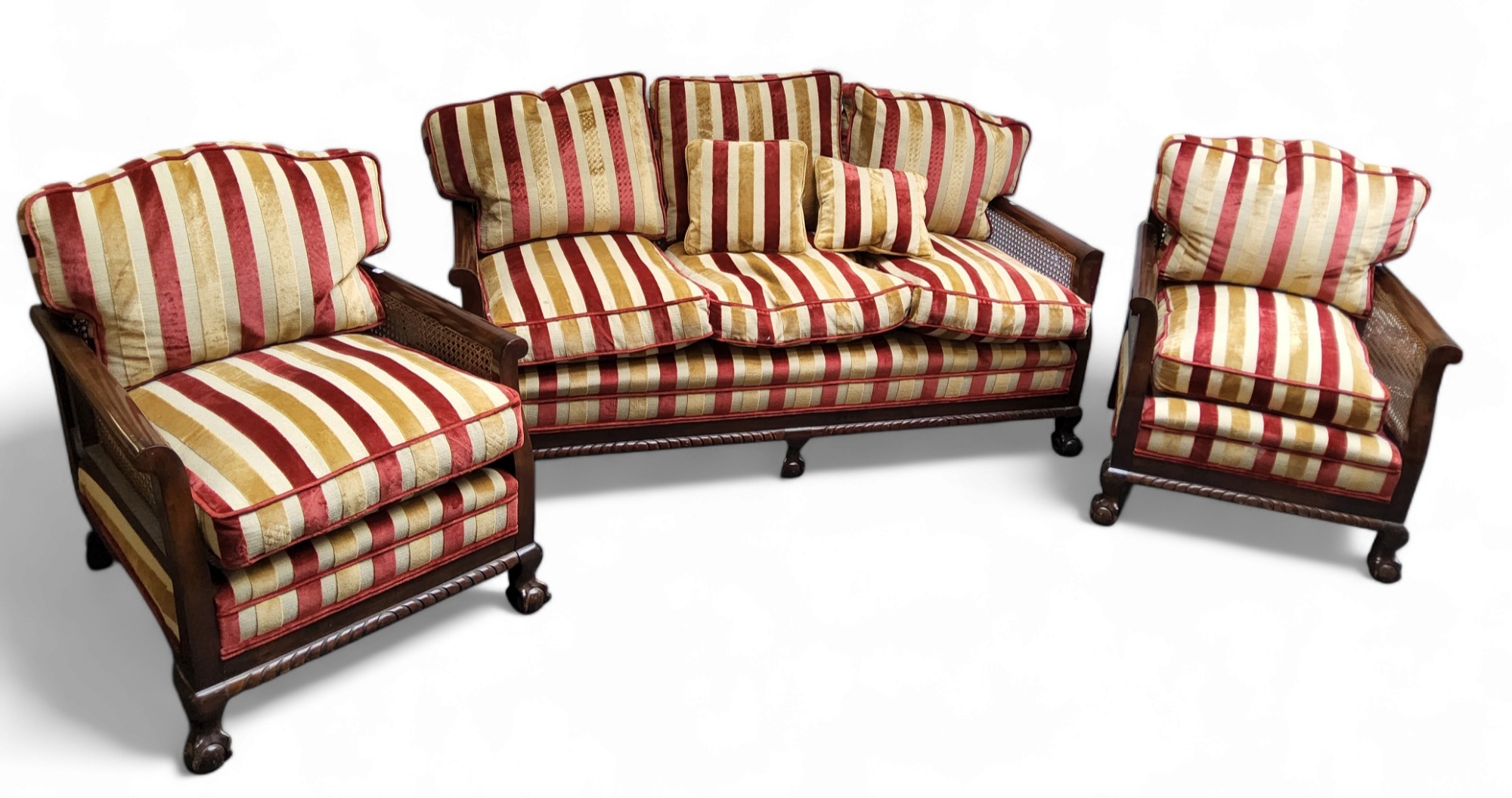 A late 19th/early 20th century mahogany bergere salon suite, comprising three seat sofa and two