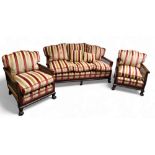 A late 19th/early 20th century mahogany bergere salon suite, comprising three seat sofa and two