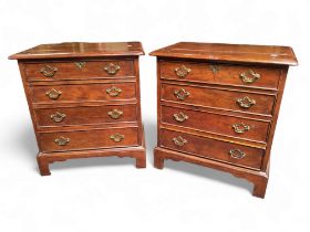 A pair of George III revival bachelors chests of drawers, each holding four long graduated cock